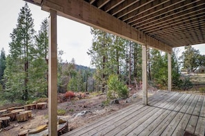 A wooden deck with a natural landscape view, surrounded by trees and a forested area. - Forest With A View - Musick Falls (Shaver Lake)