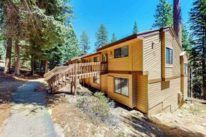 A cabin with a wooden exterior, a deck, and a path leading to it. - Big Mountain, Little Condo - Huntington Lake (Lakeshore)