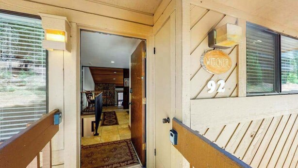 A wooden exterior with a number '92' and a sign that reads 'WITCHER'. - Big Mountain, Little Condo - Huntington Lake (Lakeshore)