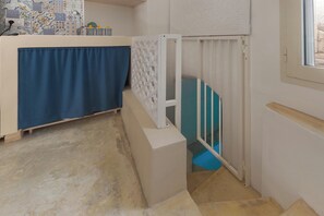 A bathroom with a shower area, a towel rack, and a tiled wall. - AquaTerrae by BarbarHouse (Alezio)