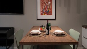 A dining table with two plates, a bottle, and a bowl of fruit. - Gallo Studio  by BarbarHouse (Bari)