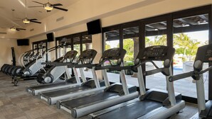 A gym with treadmills, ellipticals, and free weights. - Beachfront 2BR Condo with Hot Tub at Diamante Dunes (Cabo San Lucas)