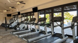 A gym with treadmills, ellipticals, and free weights. - Beachfront 2BR Condo with Hot Tub at Diamante Dunes (Cabo San Lucas)