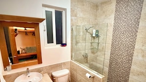 A modern bathroom with a glass-enclosed shower, a sink, and a toilet. - Breezy, Beautiful 2 Bedroom Caribbean Villa! (Sosúa)