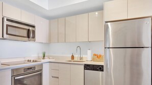 A modern kitchen with stainless steel appliances, a microwave, and a refrigerator. - Beautiful 1BR - Intracoastal View & Fitness Center (Hallandale Beach)