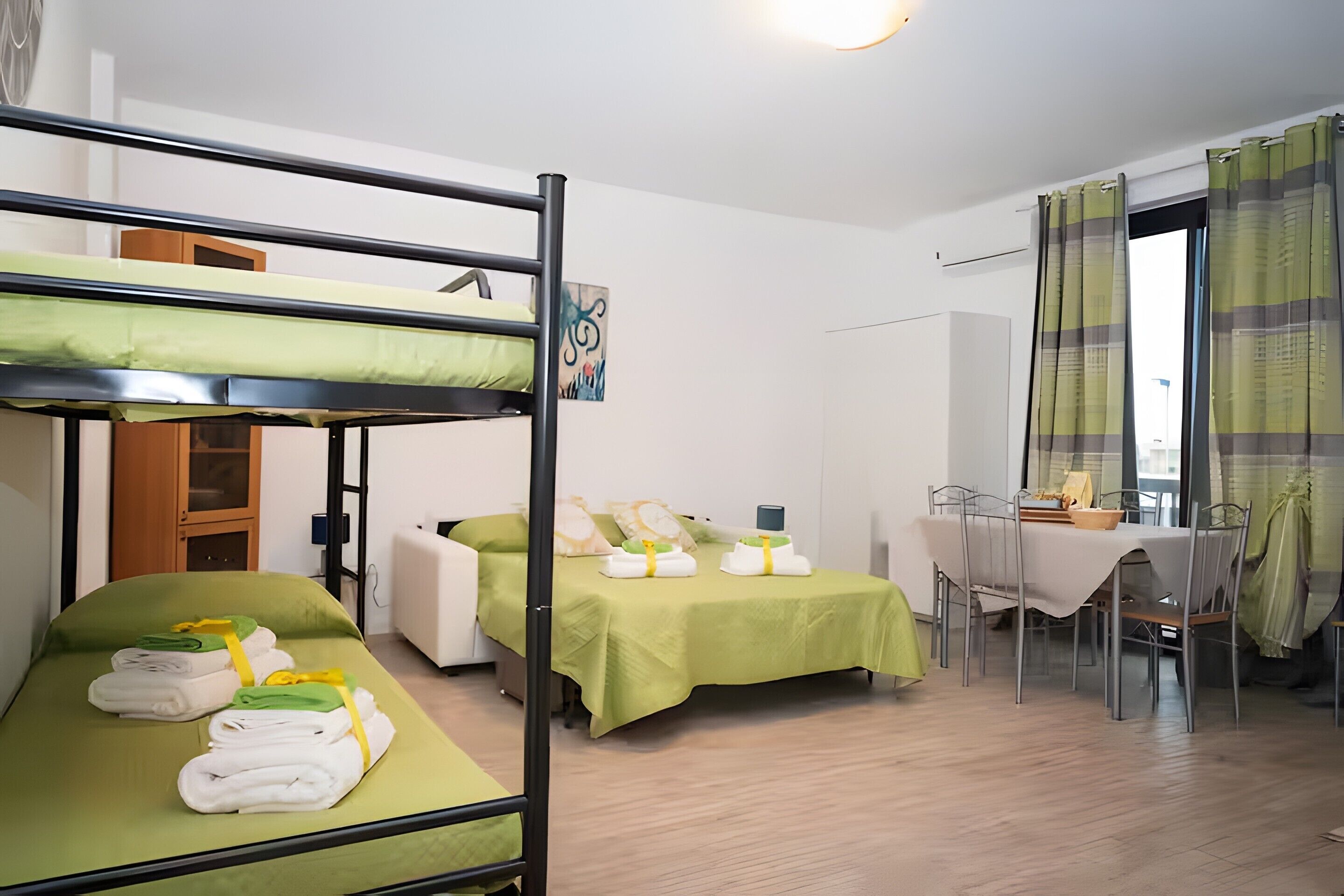 Una camera del dormitorio con letti a castello, una scrivania e un tavolo da pranzo.