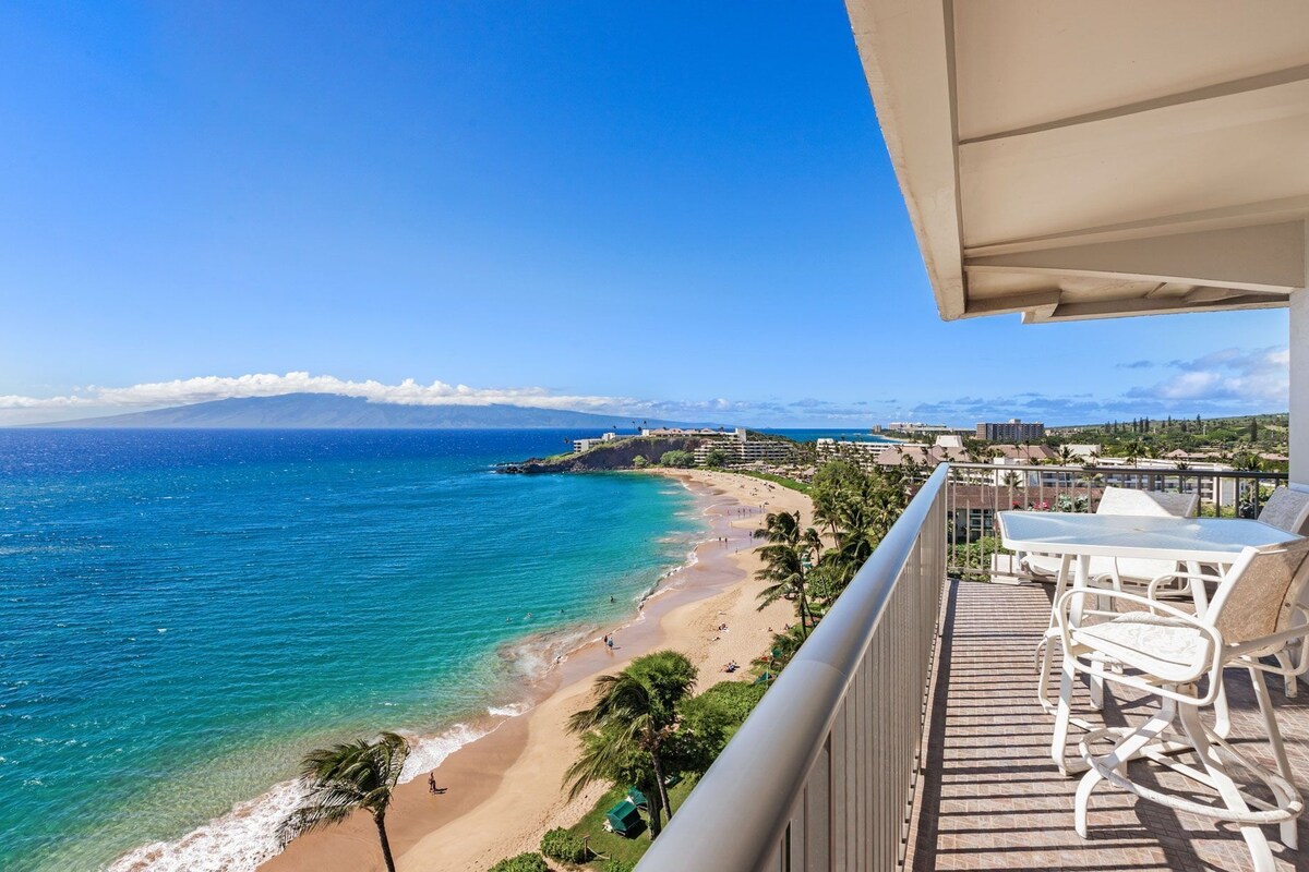 Ein Balkon mit Blick auf Strand und Meer, inklusive Tisch und Stühlen.