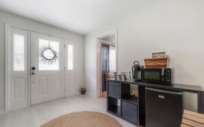 A compact kitchen with a microwave, refrigerator, and a small cabinet. - NEW 3 BR/2 BR w/Private Suite Central to Everything (Tampa)