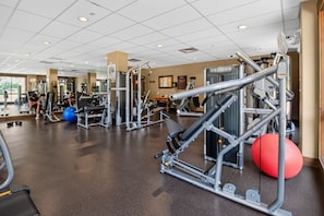 A gym with various exercise equipment, including weight machines and exercise balls. - First Tracks at Wildhorse | Gondola + Hot Tubs (Steamboat Springs)