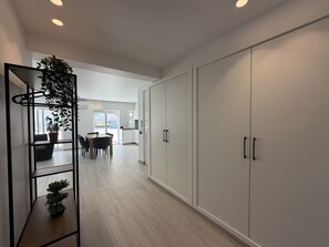 A modern interior with a dining area, kitchen, and storage cabinets. - Agua Plaza T2 With Pool AC (Albufeira)