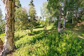 A natural outdoor area with trees and a grassy path. - Award-winning Anchorage Kitchen w/ Cook Inlet Views (Anchorage)