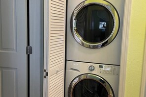 A laundry room with two stacked front-loading washing machines.