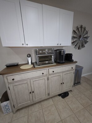 A kitchen with a built-in oven, a coffee maker, and a decorative windmill on the wall. - Wonderful condo with cool AC, pool in charming Ship Bottom.Very spacious studio. (Ship Bottom)