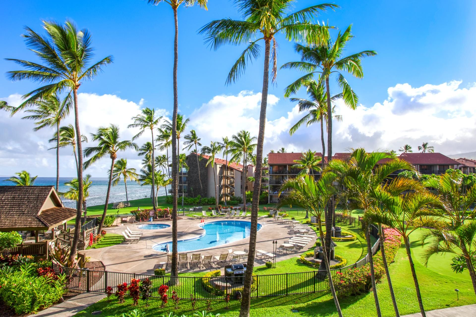 A resort with multiple swimming pools, palm trees, and ocean views.