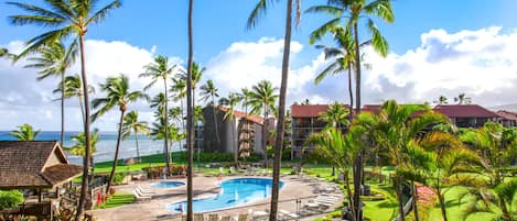 A resort with multiple swimming pools, palm trees, and ocean views.