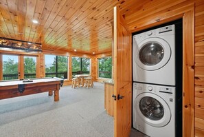 A wooden interior with a pool table, chairs, and a washing machine. - High Smokies Lodge: Game Room, Hot Tub, Pet-Friendly (Sevierville)