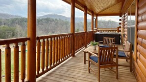 A wooden deck with a view of a forested mountain range. - Serene MTN Cabin: Indoor Pool, Hot Tub, & Game Room! (Pigeon Forge)