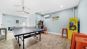 A room with a ping pong table, a gaming console, and a refrigerator. - Rooftop Deck · Heated Pool & Spa · 1 Min To Beach (Bradenton Beach)