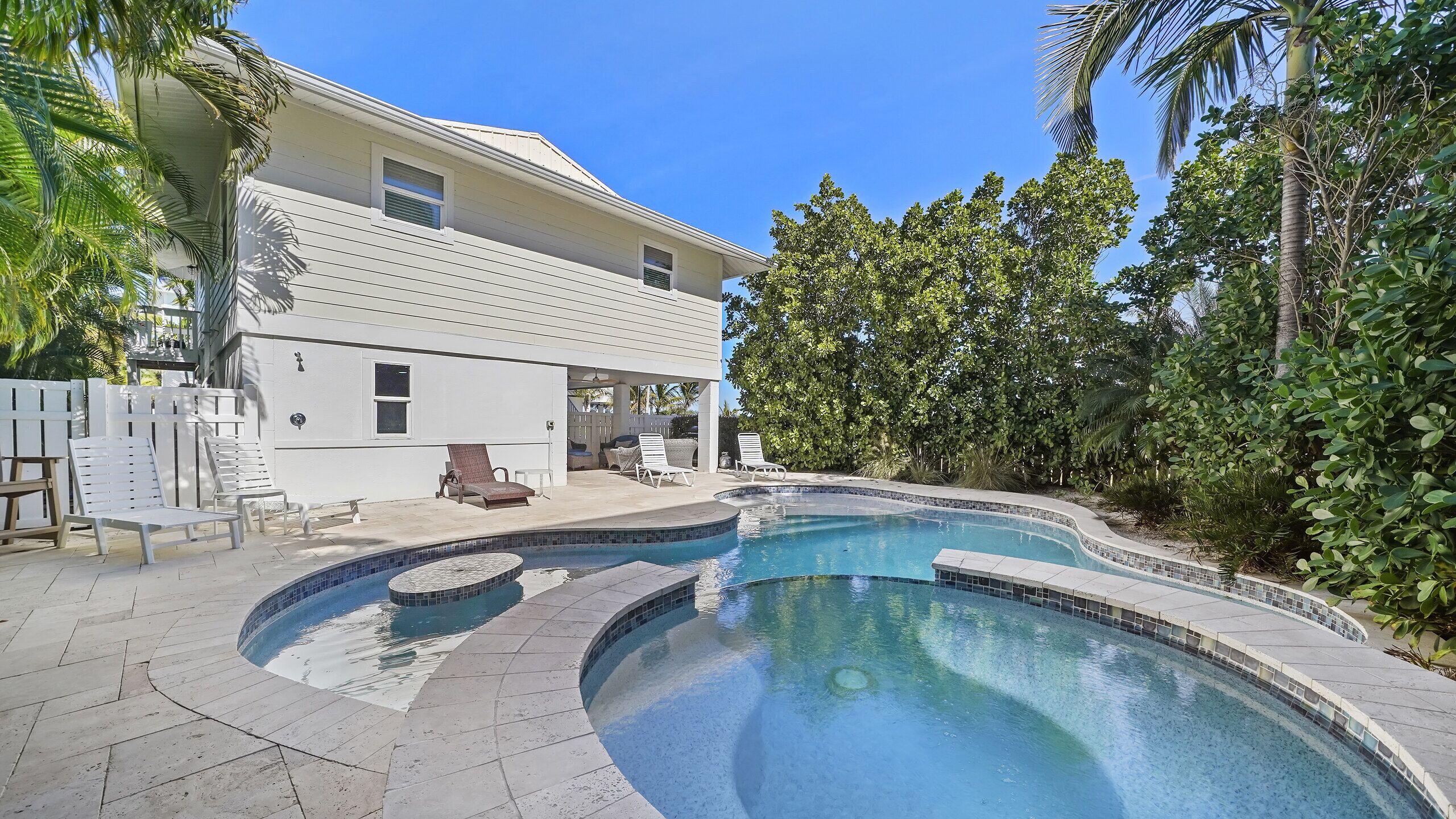 A two-story house with a swimming pool.