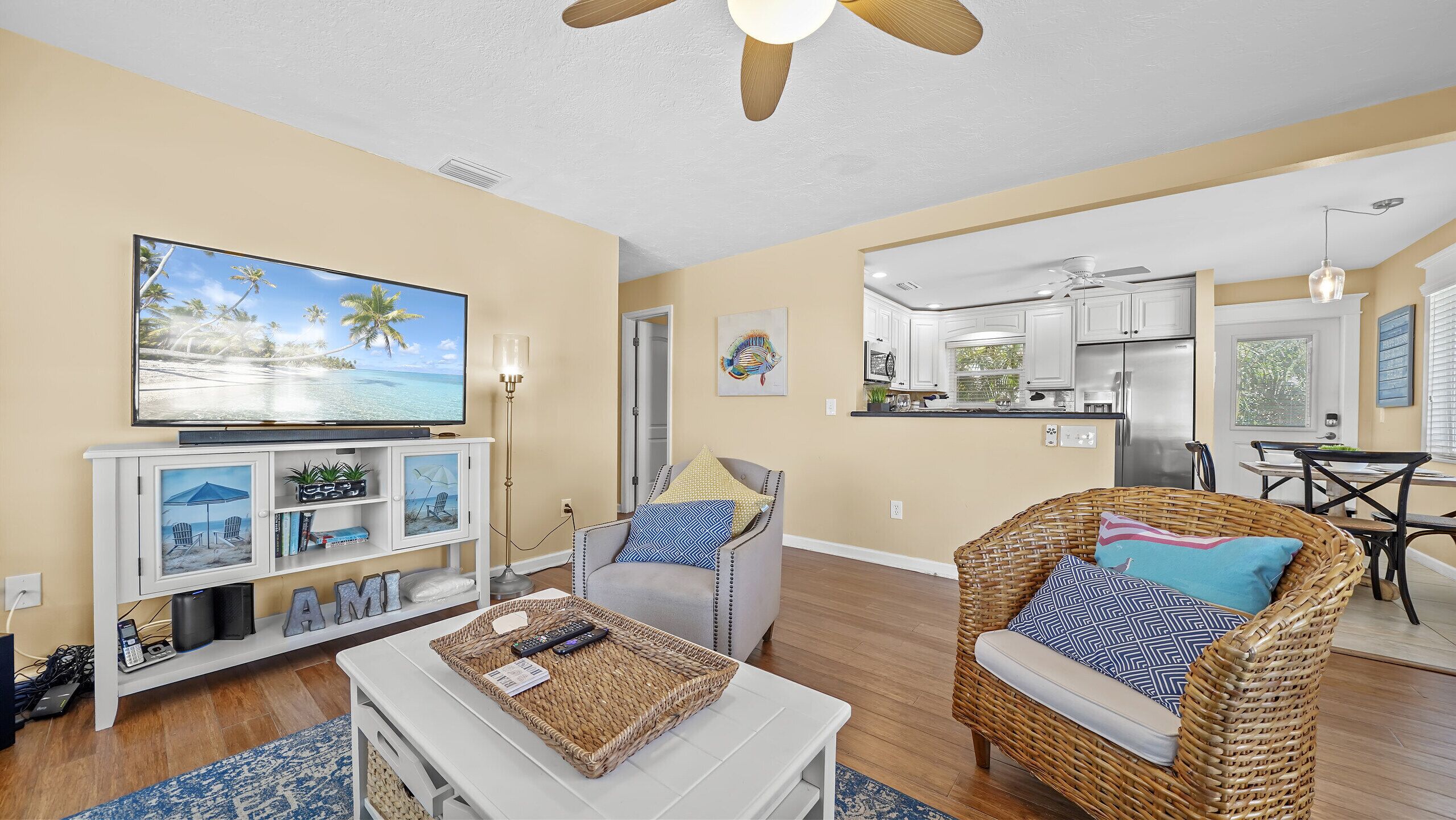 Bright coastal living room with open kitchen and cozy seating