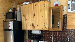 A kitchen with wooden cabinets, stainless steel appliances, a granite countertop, and a built-in microwave. - Byrd Homestead - Hill Top (Carmen)
