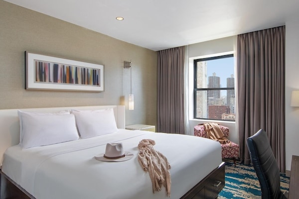 Relax into plush bedding with softly glowing bedside lighting.