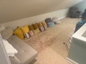 A living room with a sofa, a chair, and a television. - 3k square foot house-sleeps 12 people comfortably. (Coloma)