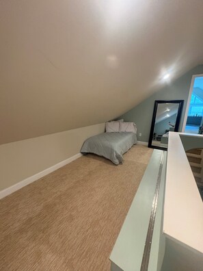 A bedroom with a bed, a desk, and a large mirror. - 3k square foot house-sleeps 12 people comfortably. (Coloma)
