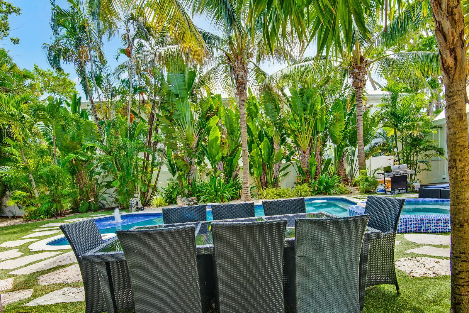 Un espace aménagé au bord de la piscine, avec un ensemble de mobilier de jardin et des chaises longues.