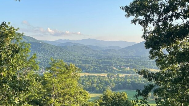 A view of a mountainous landscape with dense forest in the foreground and a clear sky. - Stunning MTN and Valley Views! 3BR*Hot Tub*Privacy (Sevierville)