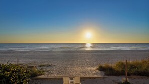 A beach with a wooden viewing platform and a sign indicating private property. - Top-Floor Gulf Front · Sunset Balcony · Heated Pool (Holmes Beach)