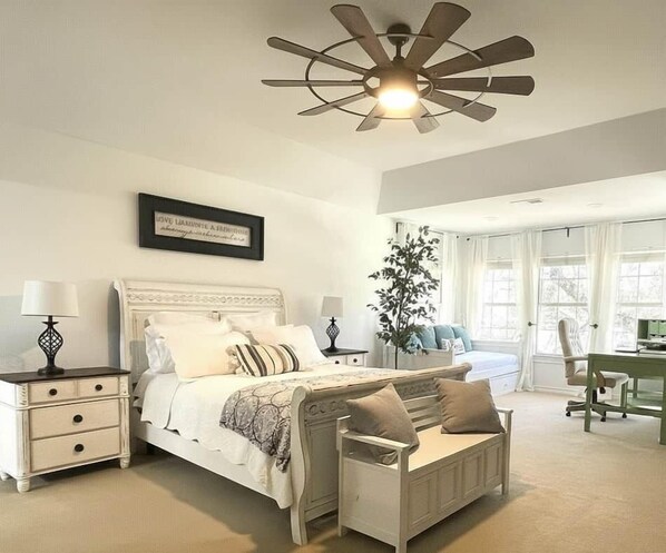 A bedroom with a bed, bedside tables, a desk, and a ceiling fan. - Resort-Style 
Backyard Retreat 
Pool-Spa & Firepit (Garden Ridge)