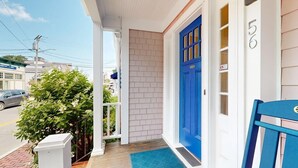 A house with a blue door, a number '56' on the wall, and a small porch with a blue mat. - Walk to Ferry & Beach from Central Oak Bluffs (Oak Bluffs)