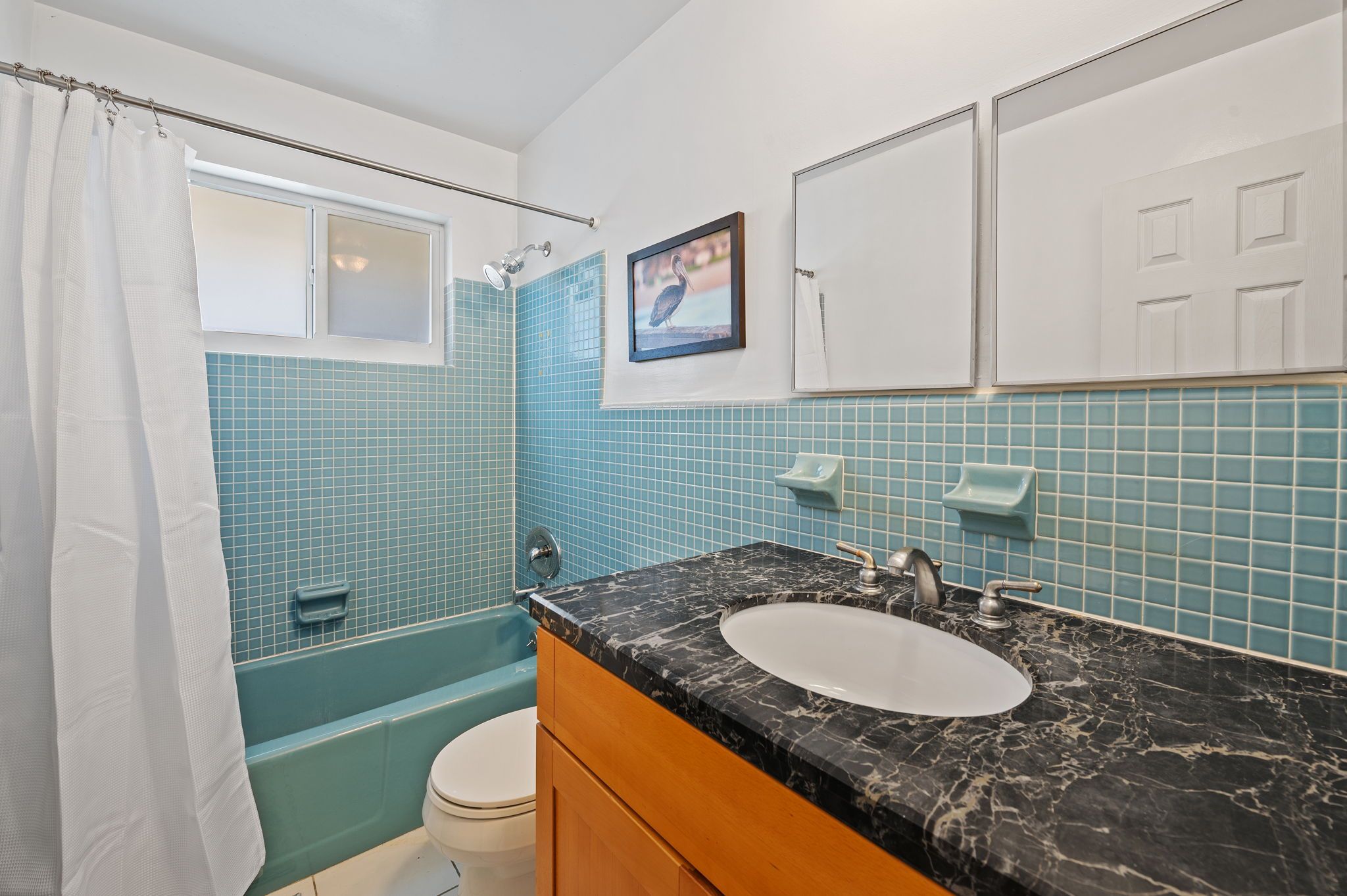 A bathroom with a bathtub, a sink, and a toilet.