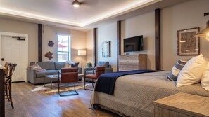 A modern bedroom with a bed, a sofa, a chair, a TV, and a desk. - Paso Park Suites by Avantstay On the Park + Walk to Downtown Dining Downtown Paso Robles (Paso Robles)