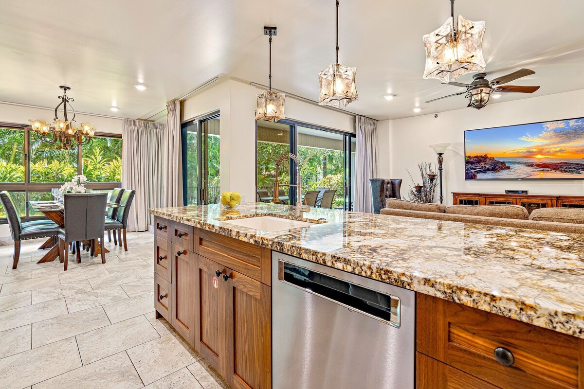 A spacious kitchen with granite countertops, stainless steel appliances, and a large island.