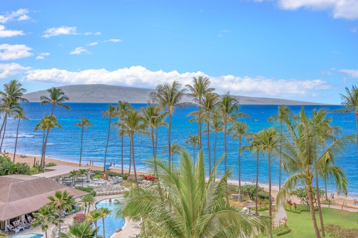 A resort with a pool, beach, and ocean view.
