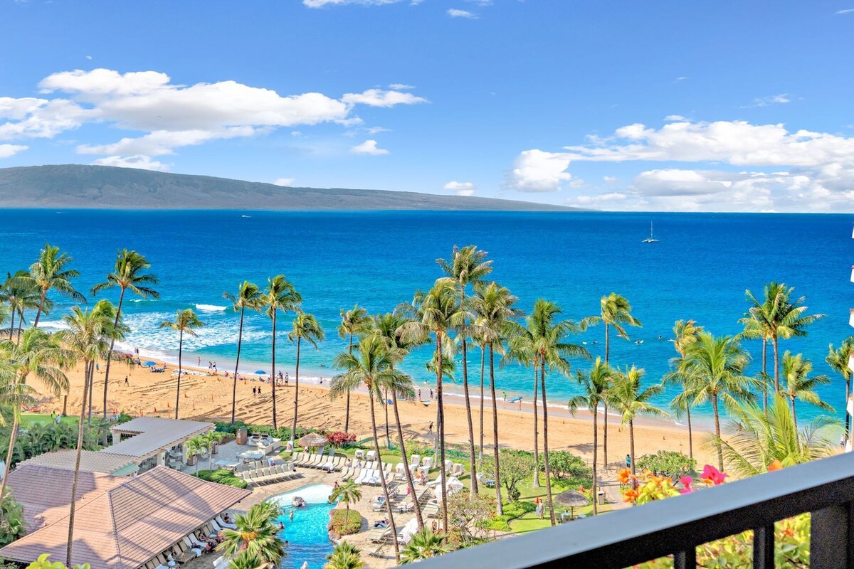 A resort with a pool, beach, and ocean view.