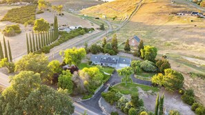 A rural property with a main house, a driveway, and surrounding fields.
