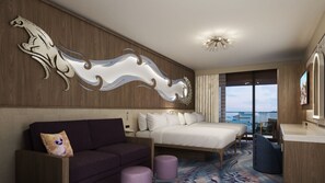 A modern hotel room with a large bed, a sofa, a decorative wall piece, and a view of the city.