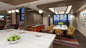 A modern dining area with a marble island, a dining table set for six, and a view of the cityscape through large windows.