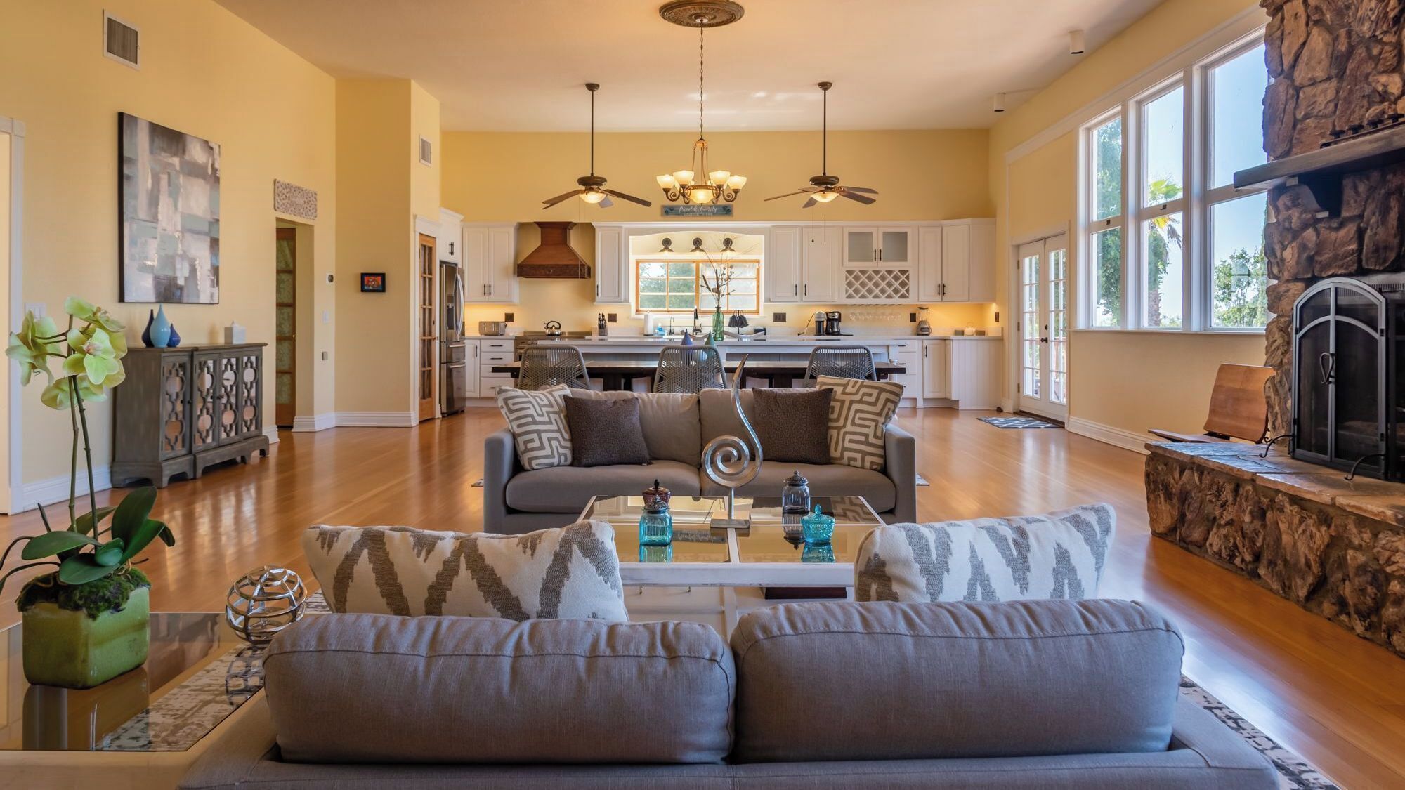 A spacious living room with a sofa, coffee table, and decorative items.
