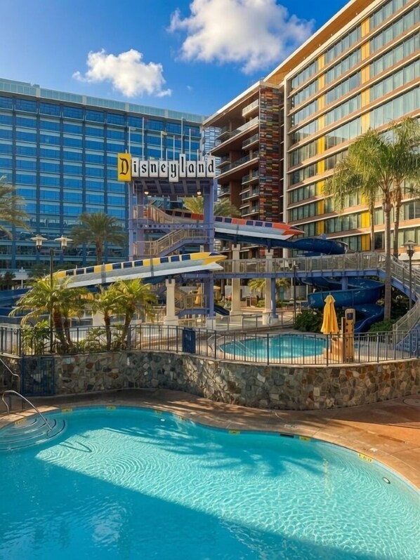 A hotel with a pool, a water slide, and a sign reading 'Disneyland.'
