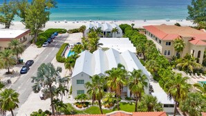 A resort with a pool, beach access, and a view of the ocean.