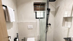 A modern bathroom with a glass shower enclosure, a toilet, and a sink. - Futuretrendhomes (Abuja)