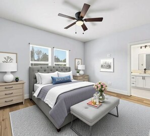 A bedroom with a bed, bedside tables, a ceiling fan, a window, and a bathroom visible through an open door. - Modern 2BR Houston Retreat 10 Min to Downtown (Houston)