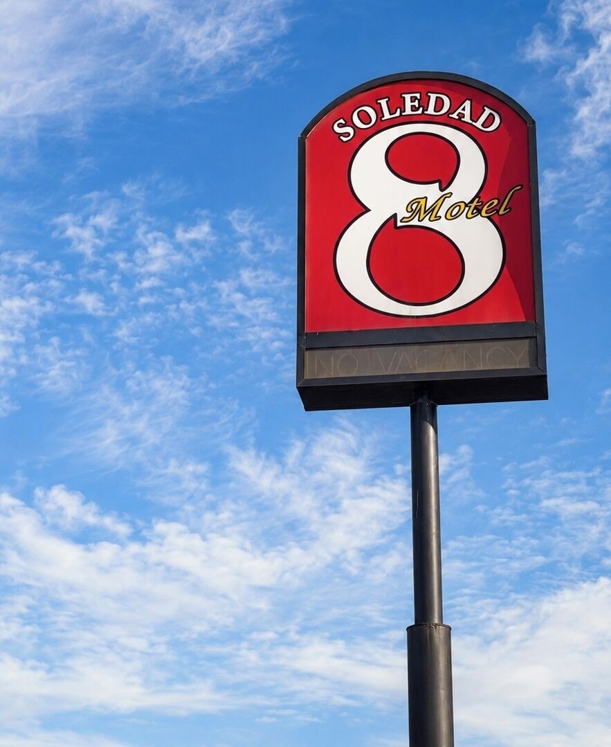 A motel sign with the name 'SOLEDAD 8 Motel' and a message indicating no vacancies.
