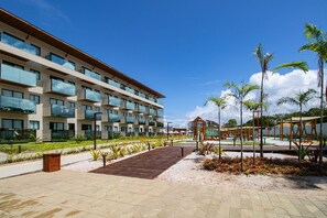 A modern hotel with multiple balconies, a central courtyard, and a pool area. - Beachfront Condos at Ipioca Beach Life Maceio by MME (Maceió)