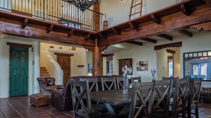 A spacious dining area with a high wooden ceiling and a staircase leading to an upper level. - Renata's Retreat by Avantstay Private Pool + Game Room Starry Escape (Templeton)