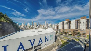 A large industrial building with the name 'TAVANI' prominently displayed. - Apartment With Barbecue in Condo With Pool Tso0403 (Balneário Camboriú)